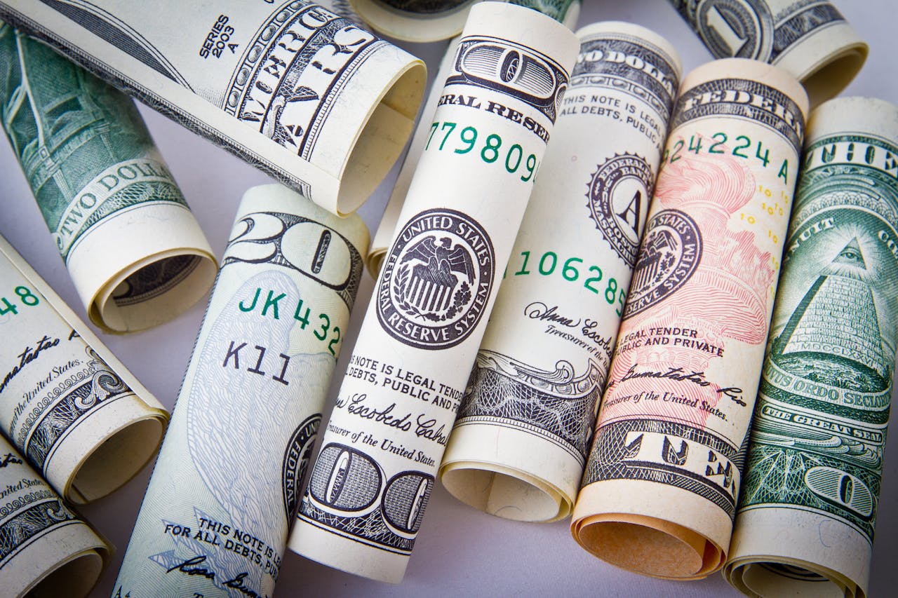 why-choose-us-01 Close-up of rolled US dollar bills symbolizing wealth, financial success, and currency.